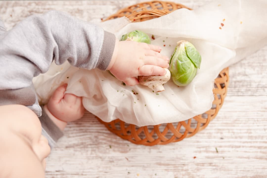 person holding knife slicing vegetable