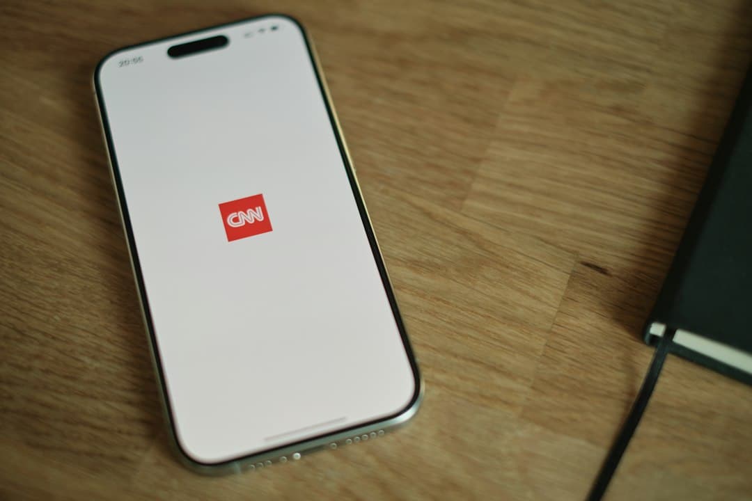 A cell phone sitting on top of a wooden table