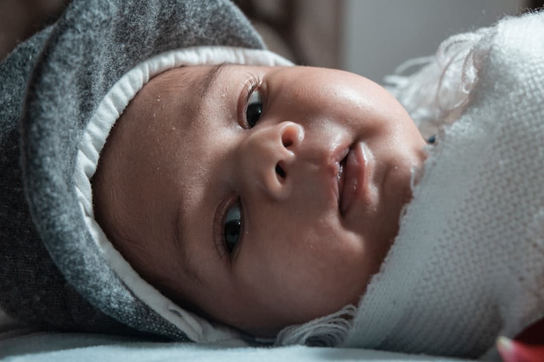 baby in white knit cap